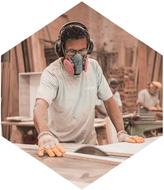 Woodworker at a saw table in a workshop